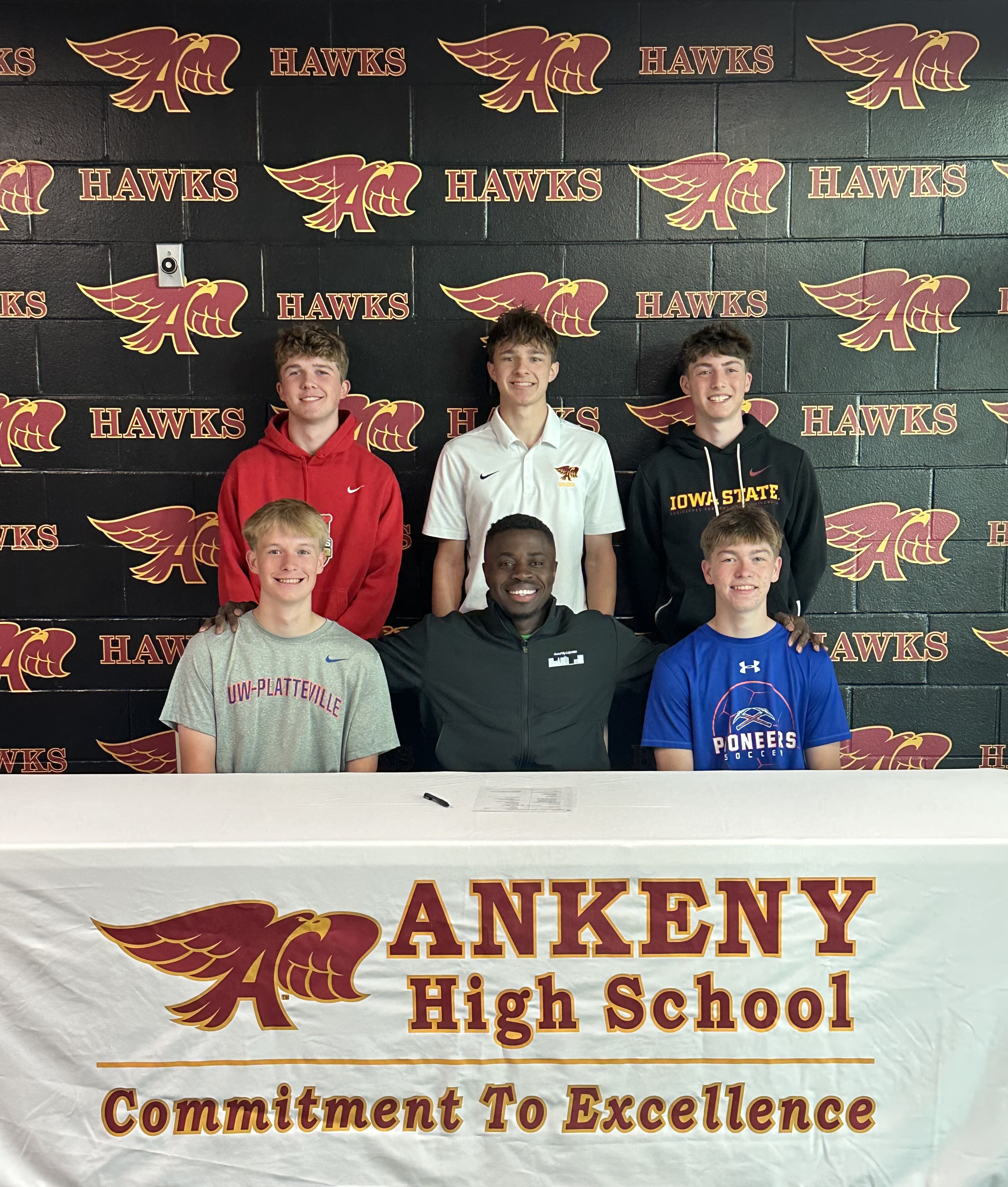 Coach Frim with players at signing day